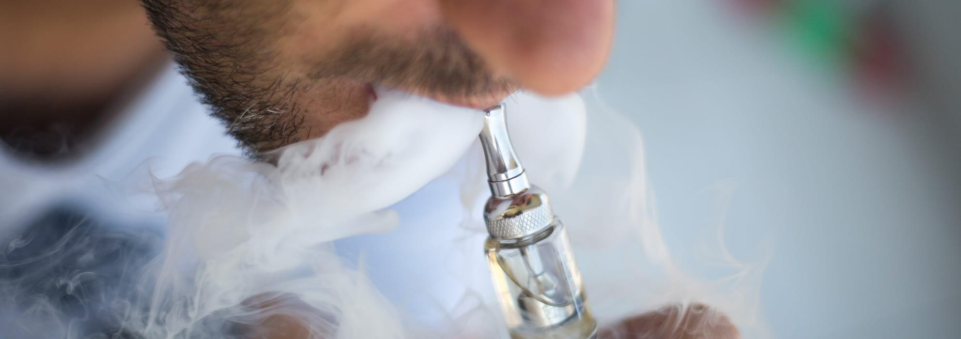 Man vaping using an e-cigarette 