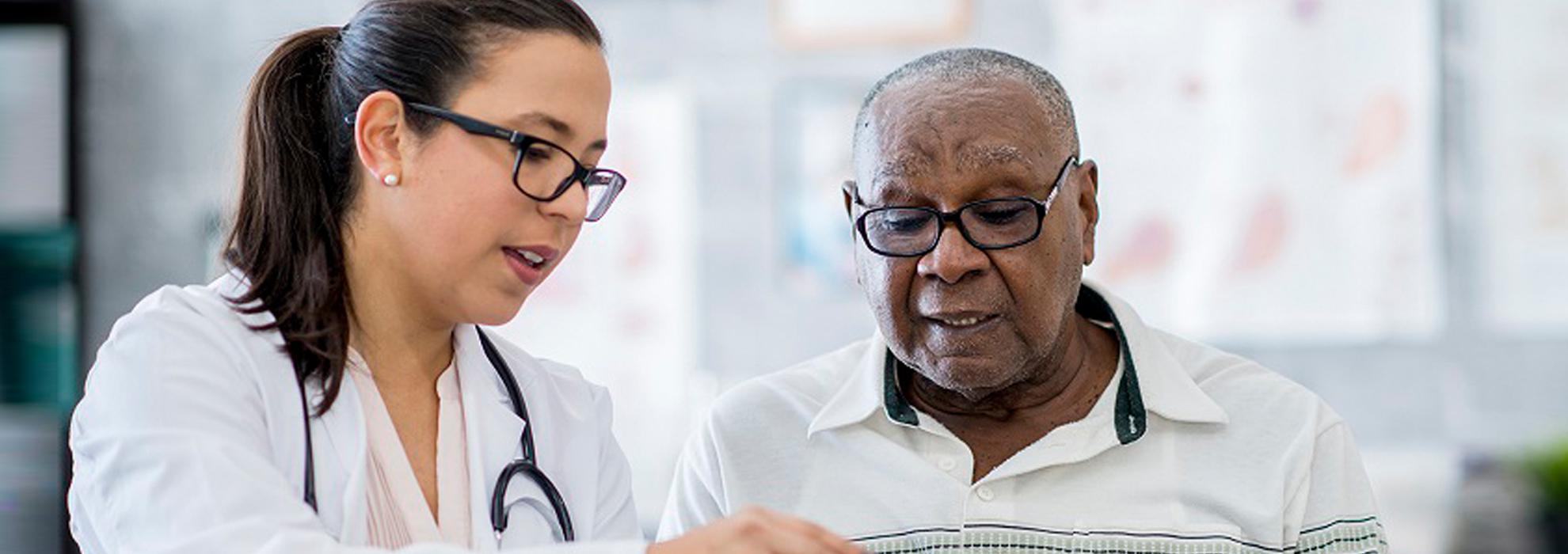 Female doctor communicating with man via book.