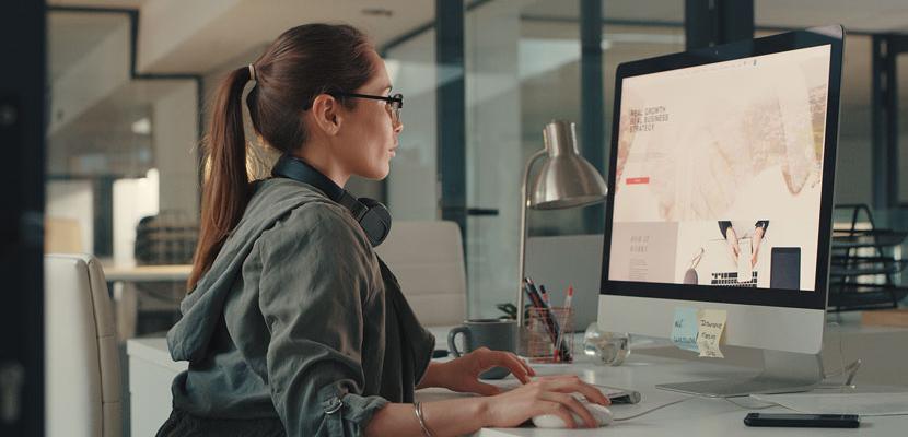 A graphic artist designing a product on her computer.